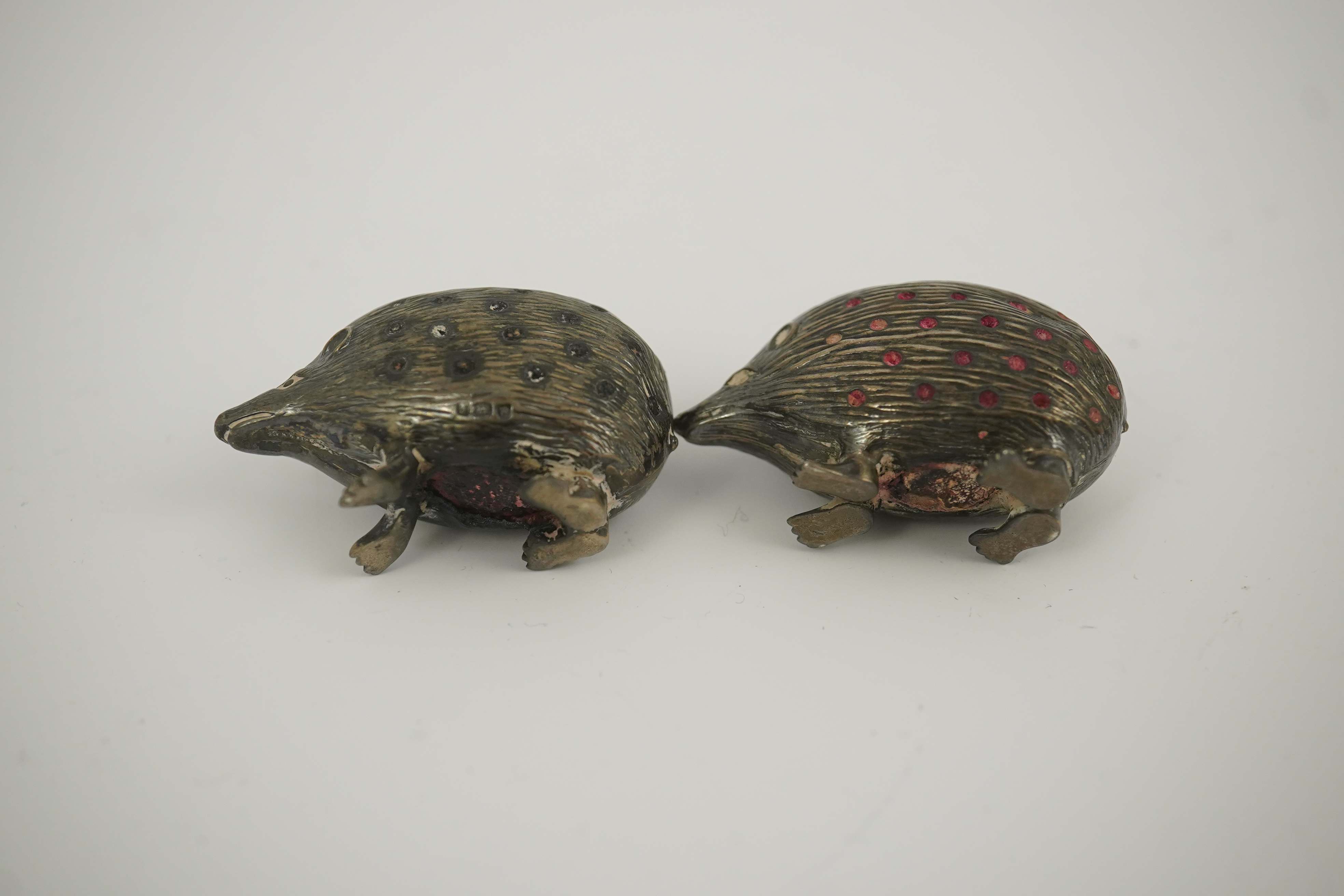 Two Edwardian silver novelty pin cushions, modelled as porcupines